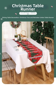Detail of Christmas table runner with festive tree prints and red tassel on a set table