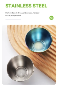 Detailed view of silver and rainbow stainless steel sauce bowls on a wooden tray