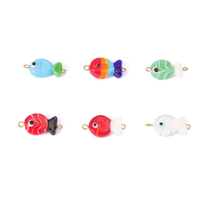 Detail of colorful handmade glass fish charms with metal rings for DIY jewelry making