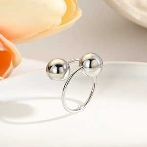 Detail of silver double-layered open ring featuring two smooth polished spheres