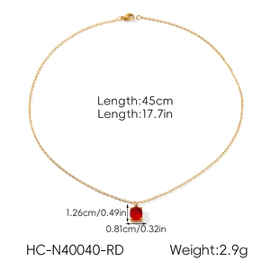 Detail view of gold necklace with red zircon pendant showing 45cm length and dimensions