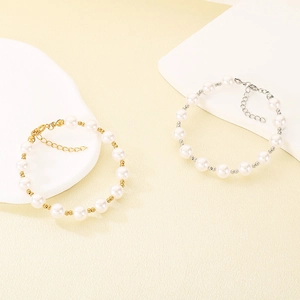 Detail of elegant pearl bracelets with adjustable gold and silver lobster clasps