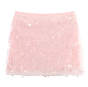 Close-up of pink sequin texture on mini skirt with shimmering light reflections
