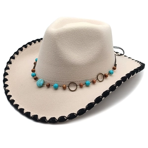 Detail of western wool fedora featuring ethnic beaded band and black woven edge trim