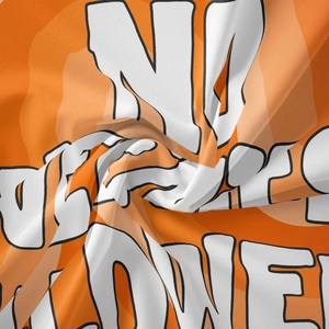 Detail of soft orange fabric with bold white and black typography and twill texture