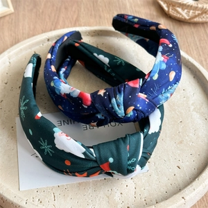 Detail of knot headbands with Santa Claus and Christmas tree patterns on a tray