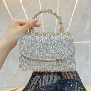 Elegant silver rhinestone evening clutch bag with twisted metallic handle for formal events