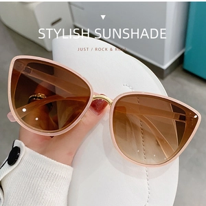 Pink cat-eye sunglasses with gradient brown lenses and gold metal nose bridge detail