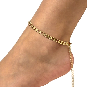 Detailed view of an 18K gold Figaro chain anklet with an adjustable extension link