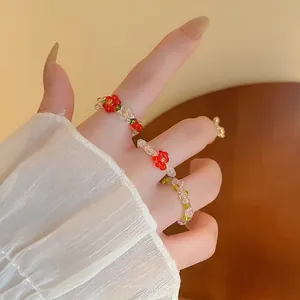 Handmade elastic beaded flower ring set in red and green floral glass bead designs