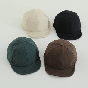 Top view of kids short brim baseball caps in beige, black, dark green and brown colors