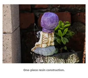 Detailed view of skeleton resin figurine with purple bandana in a fishing pose decoration