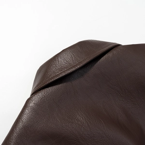 Detailed close-up of collar and fine texture on high-quality dark brown leather jacket