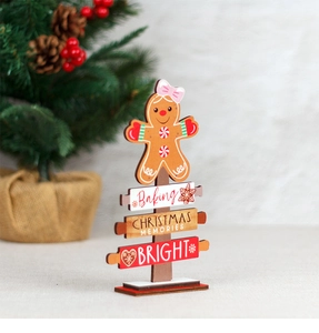 Close-up of wooden gingerbread man desk ornament with Christmas memory engravings