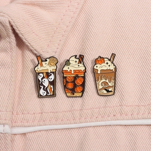 Close-up of Halloween enamel pins on denim jacket showing ghost and pumpkin drink motifs