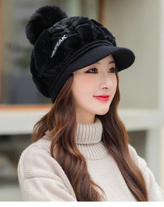 Detail of black plush winter hat featuring knit brim and white GIRLSPEAK embroidery