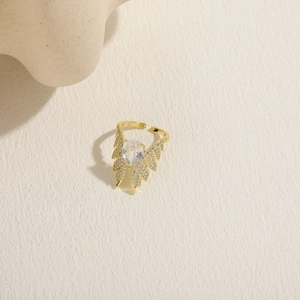 Detail of 14K gold plated ring featuring a pear-cut zircon and elegant wing design