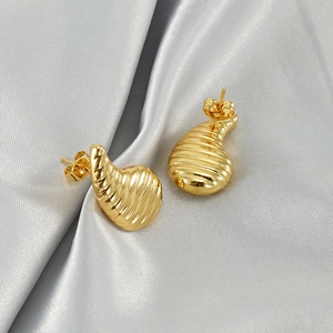 Detailed view of 18K gold plated teardrop earrings with textured horizontal ripples