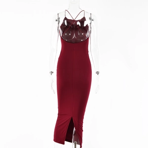 Detail of red backless bodycon dress featuring thin straps and elegant back slit