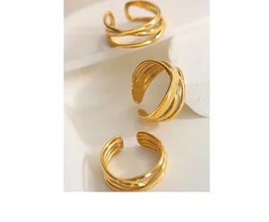 Detailed view of triple-layered golden wavy rings with polished finish and open design