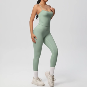 Detail of mint green yoga set featuring thin strap top and high-waisted leggings