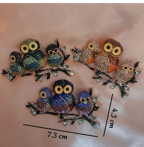 Close-up of owl family brooch with colorful rhinestones and enamel details 7.3cm x 4.3cm