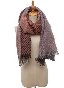 Detail of winter scarf showing orange and blue pattern texture with fringe edges