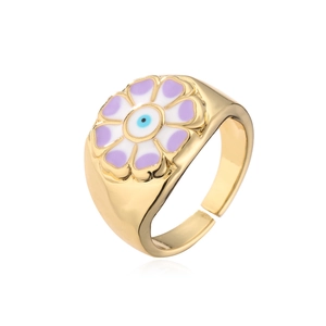 Detailed macro shot of 18K gold-plated evil eye flower ring with purple enamel