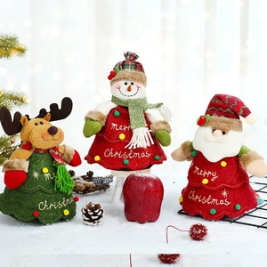 Three Christmas gift bags featuring Santa, snowman, and reindeer figures in soft plush