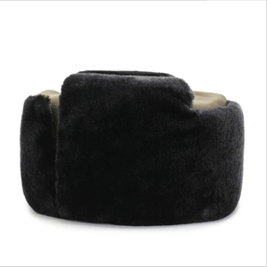 Detail of warm winter trapper hat showing black faux fur texture and brown crown panel