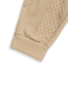 Detailed close-up of khaki jacquard knit texture and elastic ribbed cuffs on sleeve