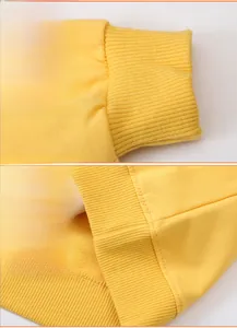 Detail of ribbed cuffs and hem on girls' yellow long sleeve sweatshirt with neat stitching