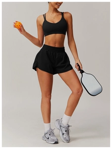 Detail of moisture-wicking black yoga set with high-waist shorts and sports bra