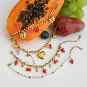 Lush display of 18K gold stainless steel fruit charm necklaces and pearl bracelets