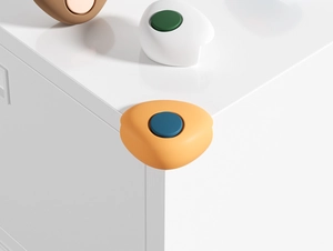 L-shaped silicone corner guards in orange, brown and white for baby safety protection