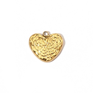 Macro detail of gold heart pendant with textured finish and wing motif on steel