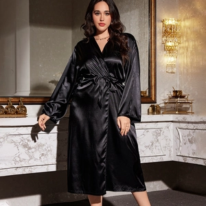 Elegant black silk satin robe for women with long sleeves and waist tie in luxury setting