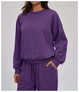 Detail of purple long sleeve crewneck sweatshirt with dropped shoulders and relaxed fit