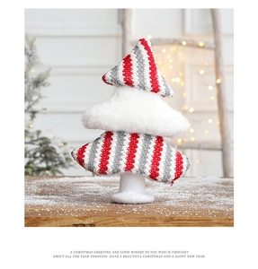 Detail of a Christmas tree tabletop ornament with red and white striped fabric and white plush base