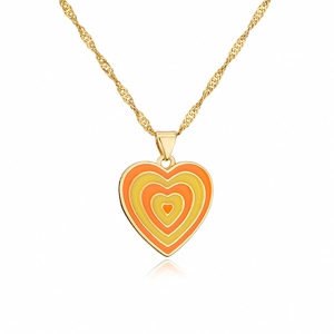 Macro detail of 18K gold-plated necklace with orange and yellow enamel heart pendant