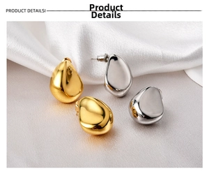 Detailed macro view of 18K gold and silver waterdrop earrings with mirror polish finish