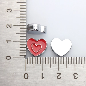 Detailed scale measurement of a double-layered red enamel heart jewelry pendant