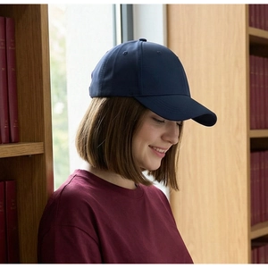 Close-up of a navy blue baseball cap with structured panels and a curved brim
