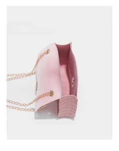 Macro view of the pink faux crocodile texture bag showing interior space and golden chain
