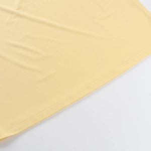 Detail of the high-quality yellow knit fabric with smooth double-needle flat stitching
