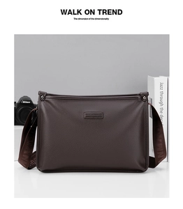 Detailed view of the dark brown lychee leather texture and embossed logo on the men's bag
