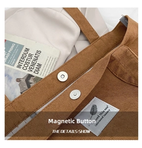 Detail of brown corduroy bag showing magnetic button closure and logo patch
