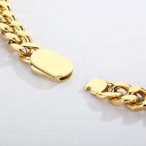 Macro shot of gold-plated titanium steel Cuban chain showcasing the secure lobster clasp