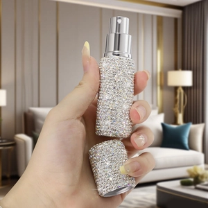 Close-up of luxury 10ml travel spray bottle with sparkling silver rhinestones