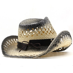 Detail of raffia straw cowboy hat with gradient edges and leather band with studs